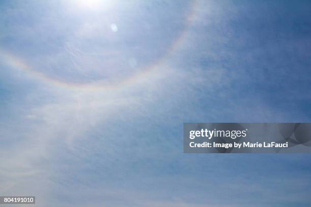 rainbow halo sun flare in the sky - sky sun stock-fotos und bilder