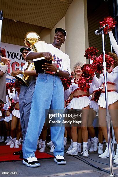 Michael Jordan of the Chicago Bulls celebrates at the Bulls' NBA Championship parade in Chicago, Illinois. NOTE TO USER: User expressly acknowledges...