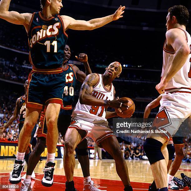 Dennis Rodman of the Chicago Bulls looks to make a move against Detlef Schrempf of the Seattle SuperSonics during Game Six of the 1996 NBA Finals at...