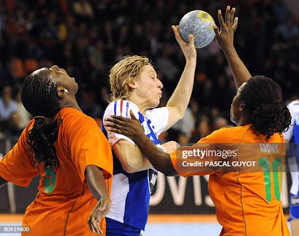 French Veronique Pecqueux-Rolland fights for the ball with Ivory Coast's Abony N'guessan Robeace and Paula Gondo Bredou on March 28, 2008 in Nimes,...