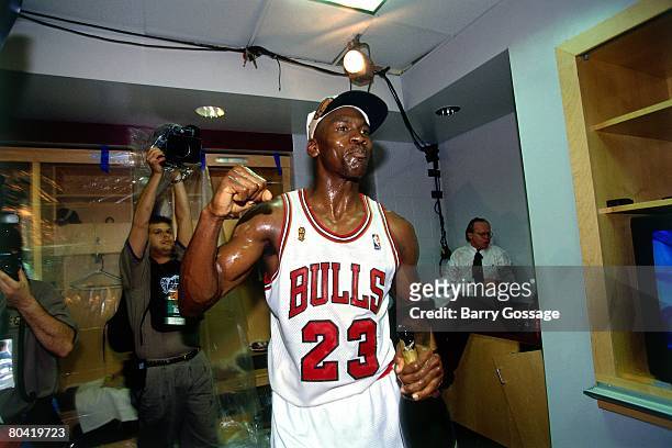 Michael Jordan of the Chicago Bulls celebrates winning the NBA title after defeating the Seattle SuperSonics in Game Six of the 1996 NBA Finals at...
