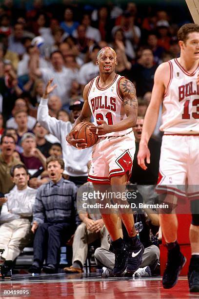 Dennis Rodman of the Chicago Bulls grabs a rebound against the Seattle SuperSonics during Game Six of the 1996 NBA Finals at the United Center on...