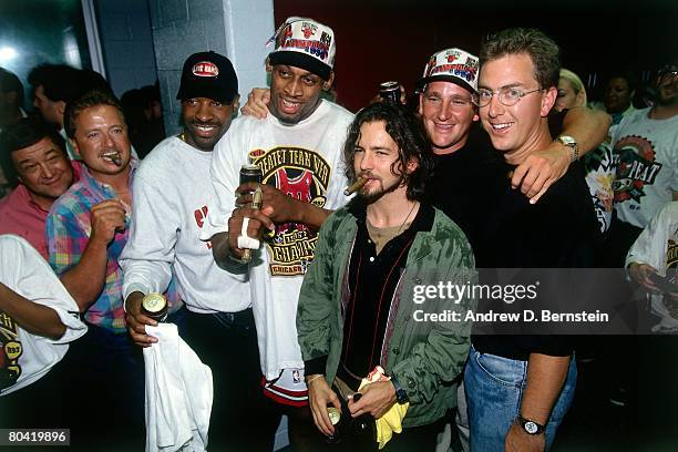 Dennis Rodman of the Chicago Bulls poses for a photo with Pearl Jam lead singer Eddie Vedder after defeating the Seattle SuperSonics in Game Six of...