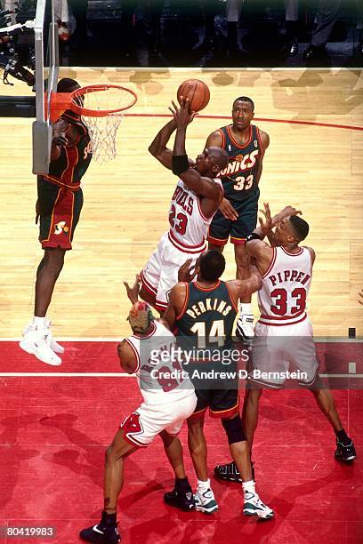 Michael Jordan of the Chicago Bulls goes up for a shot against Sam Perkins of the Seattle SuperSonics during Game Six of the 1996 NBA Finals at the...