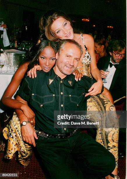 Models Carla Bruni and Naomi Campbell pose with designer Gianni Versace at The Rhythm of Life Fashion Ball in aid of the Rainforest Foundation at the...