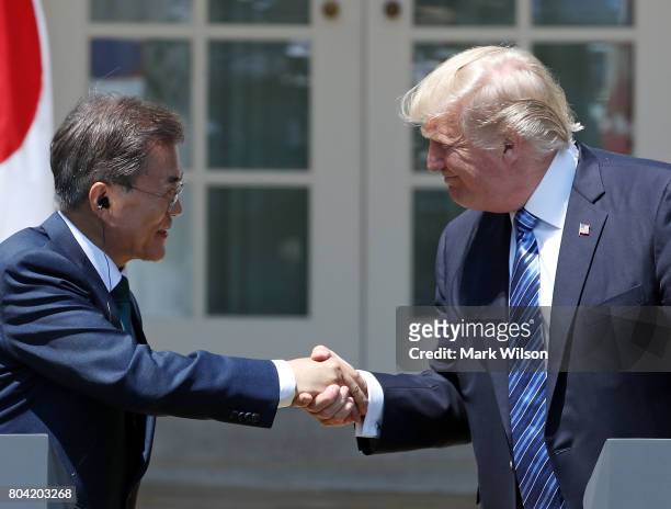 President Donald Trump and South Korean President Moon Jae-in shake hands while delivering joint statements in the Rose Garden of the White House on...