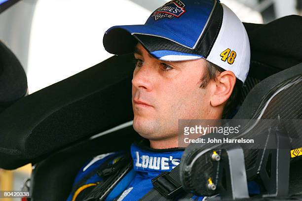 Jimmie Johnson, driver of the Lowe's Chevrolet, sits in his car during qualifying for the NASCAR Sprint Cup Series Goody's Cool Orange 500 at...