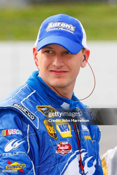 Michael McDowell, driver of the Aaron's Dream Machine Toyota, stands on the grid during qualifying for the NASCAR Sprint Cup Series Goody's Cool...