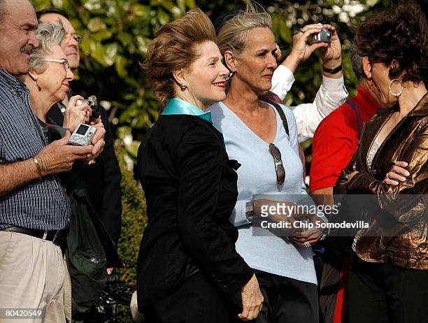 First lady Laura Bush is surrounded by high school friends while watching her husband's helicopter land on the South Lawn of the White House with...