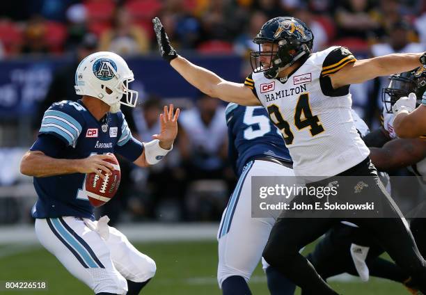 June 25, 2017; Toronto, Ontario, CAN; Justin Capicciotti of the Hamilton Tiger-Cats pressures Ricky Ray of the Toronto Argonauts. Toronto Argonauts...