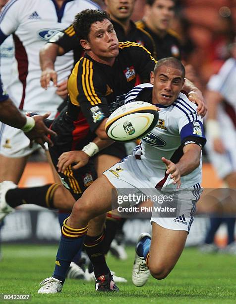 Daniel Bowden of the Highlanders is tackled by Callum Bruce of the Chiefs during the round seven Super 14 match between the Chiefs and the...