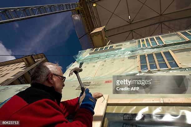 Man works on wooden buildings under construction on March 18, 2008 in Vaxjo, south of Sweden. The Swedish city of Vaxjo was awarded in 2007 the...