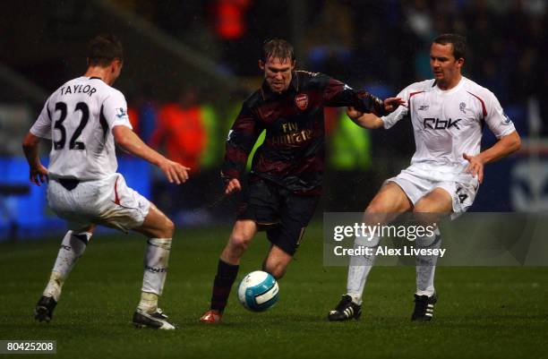 Matt Taylor and Kevin Davies of Bolton attempt to stop Alex Hleb of Arsenal during the Barclays Premiership match between Bolton Wanderers and...