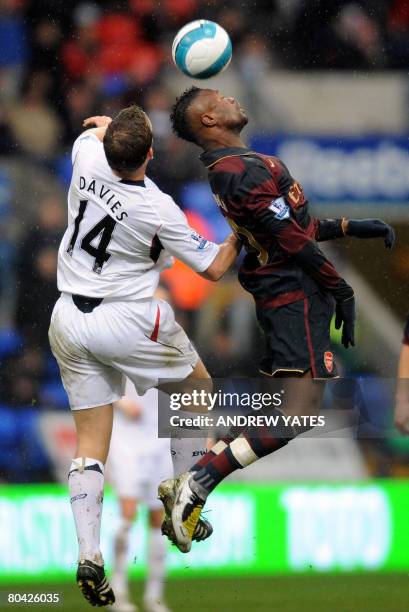 Arsenal's French defender William Gallas wins a header from Bolton Wanderers' English forward Kevin Davies during the English Premier league football...