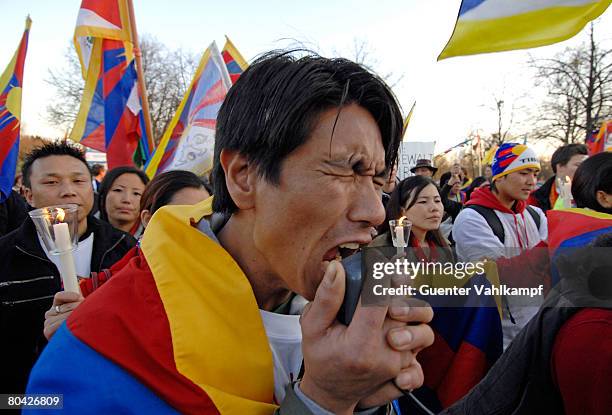 Free Tibet" activist shouts into a megaphone during a demonstration at the Olympia stadion against the Chinese occupation of Tibet and the violent...
