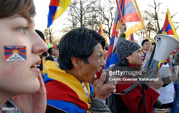 Free Tibet" activist shouts into a megaphone during a demonstration at the Olympia stadion against the Chinese occupation of Tibet and the violent...