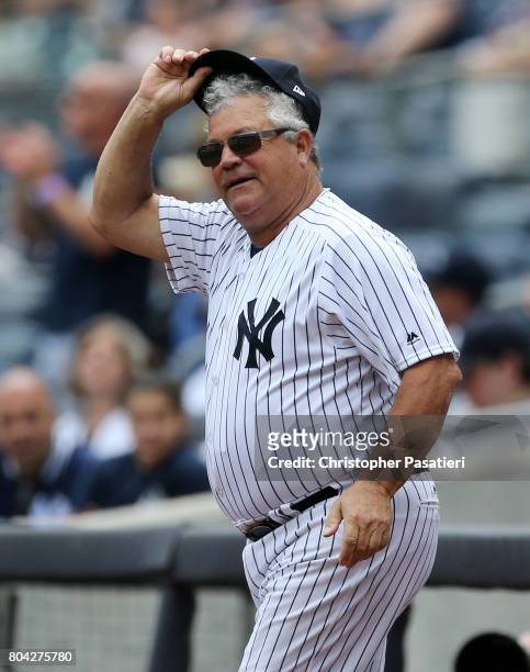 Former New York Yankees catcher Rick Cerone acknowledges the crowd after being introduced for the 71st Annual Old Timers Day at Yankee Stadium on...