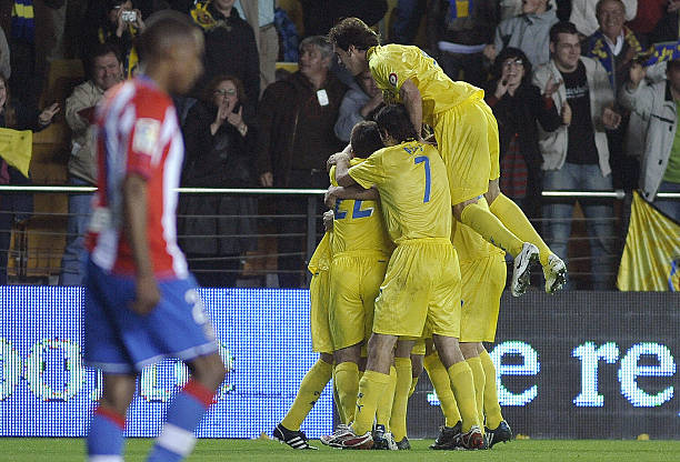 Villarreal's players celebrate their third goal during their Spanish league football match against Atletico Madrid at Madrigal Stadium in Villarreal...
