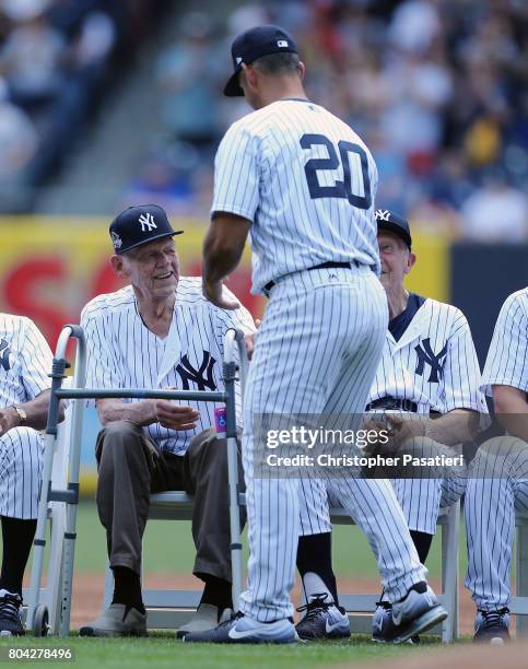Former New York Yankees catcher Jorge Posada shakes the hand of former pitcher Don Larson after being introduced for the 71st Annual Old Timers Day...