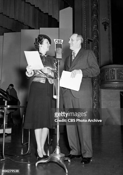Ballroom dancer Irene Castle stands at a CBS microphone with Gabriel Heatter host of the CBS Radio human interest program "We, the People." Image...