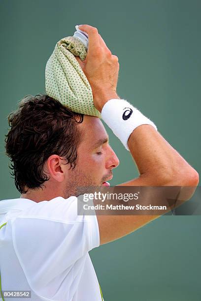 Ivo Karlovic of Croatia puts an ice bag on his head during a match against Julien Benneteau of France during day six of the Sony Ericsson Open at the...
