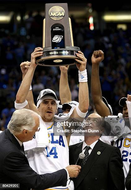 Lorenzo Mata-Rael of the UCLA Bruins hoists the West Regional trophy next to his coach Ben Howland following their victory over the Xavier Musketeers...