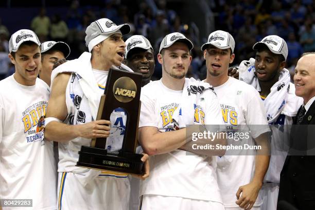 Lorenzo Mata-Rael and Kevin Love of the UCLA Bruins stand with the West Regional trophy following their victory over the Xavier Musketeers in the...