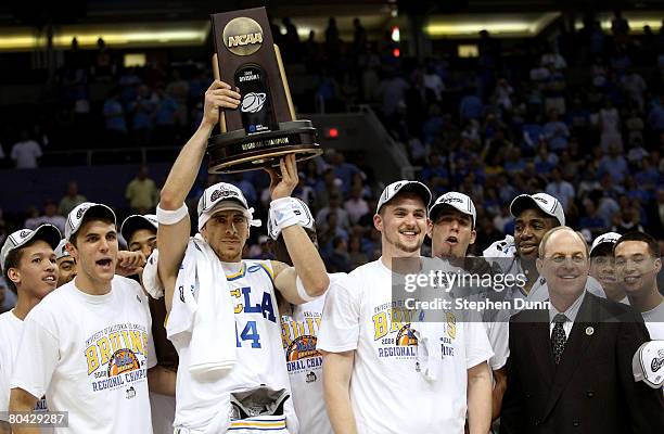 Lorenzo Mata-Rael of the UCLA Bruins hoists the West Regional trophy next to his coach Ben Howland and teammate Kevin Love following their victory...