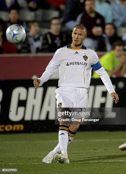 David Beckham of the Los Angeles Galaxy delivers a pass to a teammate against the Colorado Rapids at Dick's Sporting Goods Park on March 29, 2008 in...