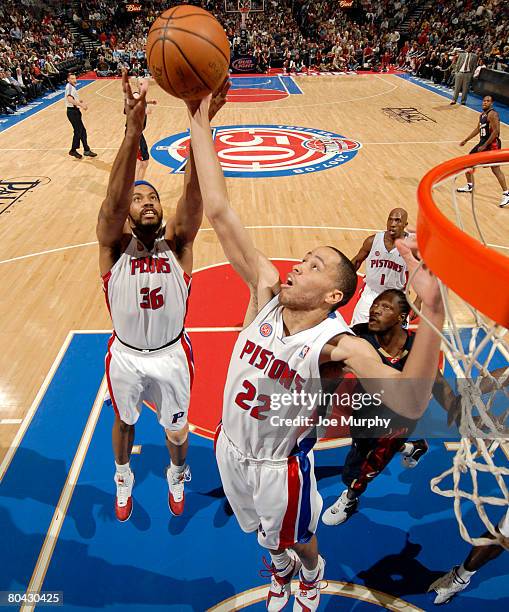 Tayshaun Prince and Rasheed Wallace of the Detroit Pistons pull down a rebound past Ben Wallace of the Cleveland Cavaliers on March 29, 2008 at the...