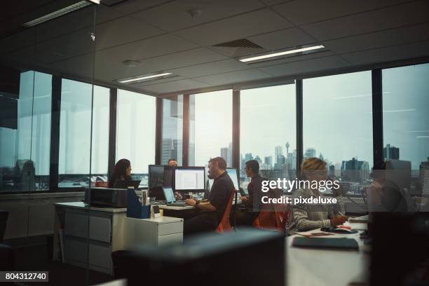 this office stays abuzz with productivity - busy office stock pictures, royalty-free photos & images