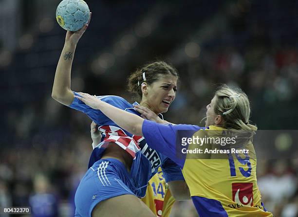 Andrea Penezic of Croatia is challenged by Johanna Ahlm of Sweden during the women's handball Olympic qualification tournament match between Sweden...