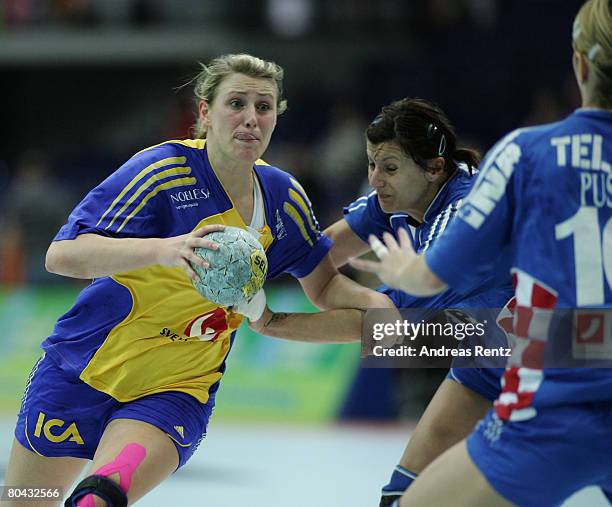 Johanna Ahlm of Sweden is challenged by Petra Starcek of Croatia during the women's handball Olympic qualification tournament match between Sweden...