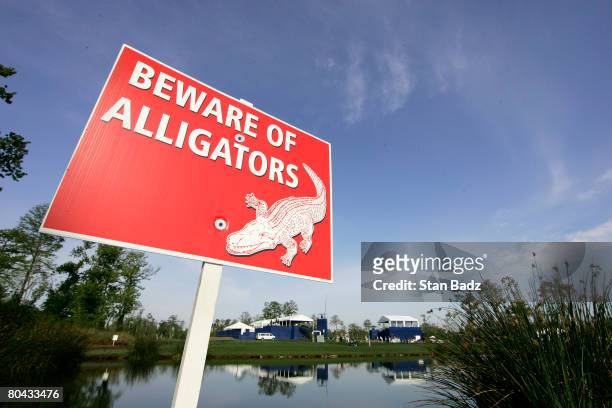Posted sign warns of alligators on the course during the completion of the third round of the Zurich Classic of New Orleans at TPC Louisiana on March...