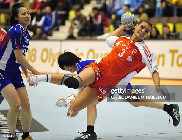 Verten Orsolya from Hungary throws the ball next to Sakamoto Tomoka from Japan, during the women handball 2008 Olympic qualification tournament in...