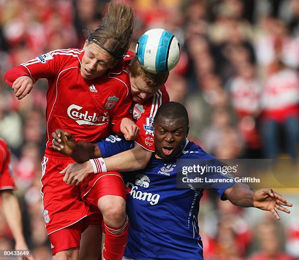 Ayegbeni Yakubu of Everton is beaten to the ball by Lucas and John Arne Riise of Liverpool during the Barclays Premier League match between Liverpool...