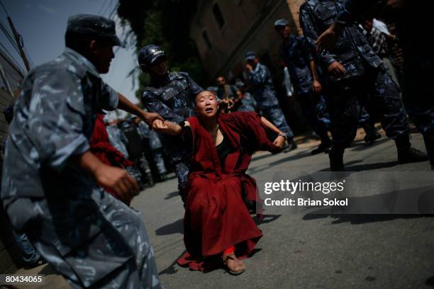 Tibetan Buddhist nun is forcibly detained by Nepali police during a pro-Tibetan protest outside of the Chinese consulate March 30, 2008 in Kathmandu,...