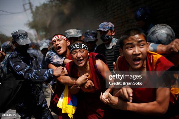 Tibetan Buddhist monks are forcibly detained by Nepali police during a pro-Tibetan protest outside of the Chinese consulate March 30, 2008 in...