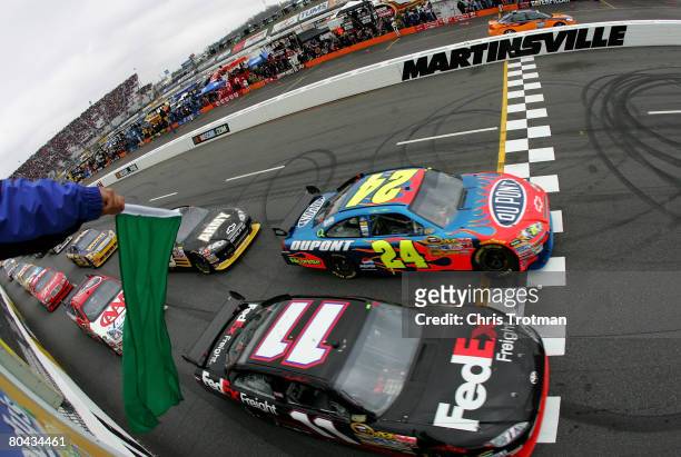 Jeff Gordon, driver of the Dupont Chevrolet, leads Denny Hamlin, driver of the FedEx Freight Toyota, at the start of the NASCAR Sprint Cup Series...