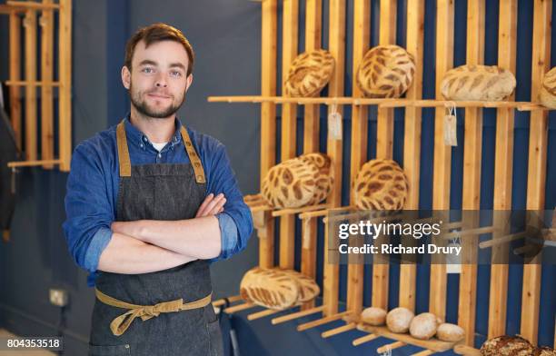 baker in artisan bakery - baker stock-fotos und bilder