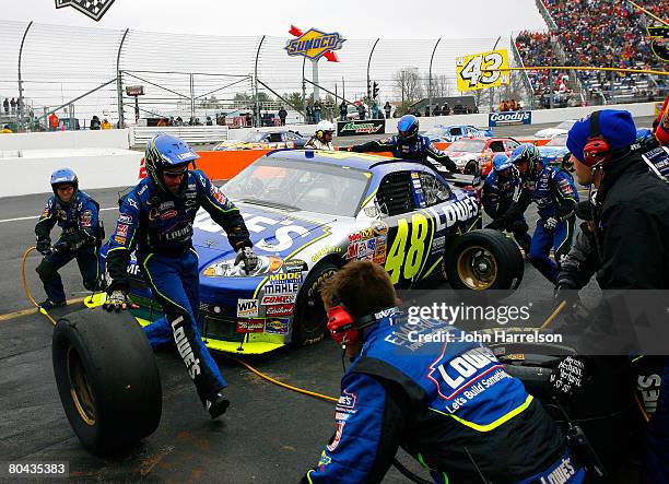 Jimmie Johnson, driver of the Lowe's Chevrolet, makes a pit stop during the NASCAR Sprint Cup Series Goody's Cool Orange 500 at Martinsville Speedway...