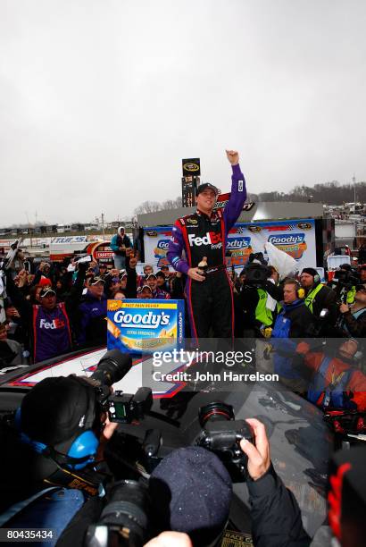 Denny Hamlin, driver of the FedEx Freight Toyota, celebrates in victory lane after winning the NASCAR Sprint Cup Series Goody's Cool Orange 500 at...