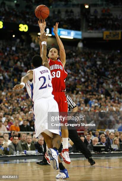 Davidson's Stephen Curry (30) lofts a shot over Kansas' Cole Aldrich (45)  during first half action on Sunday, March 30, 2008. The Kansas Jayhawks  faced the Davidson Wildcats in the NCAA Midwest