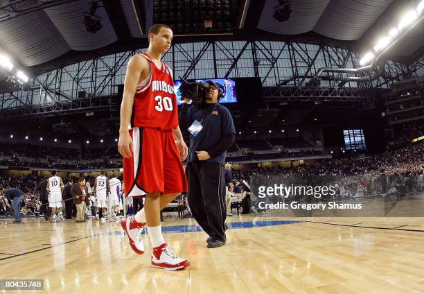 Stephen Curry of the Davidson Wildcats walks off the court after he lost 59-57 against the Kansas Jayhawks during the Midwest Regional Final of the...