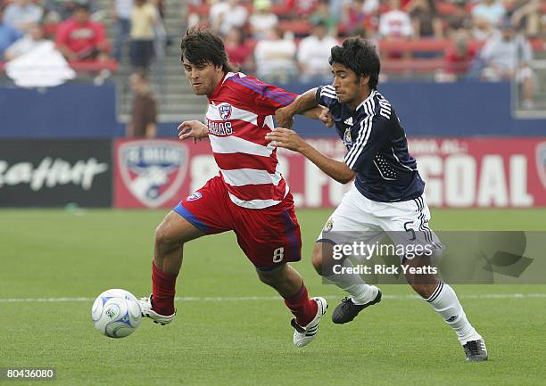 Juan Toja of FC Dallas takes control of the ball from Paulo Nagamura of the Chivas USA as seen during the match between Chivas USA and FC Dallas at...