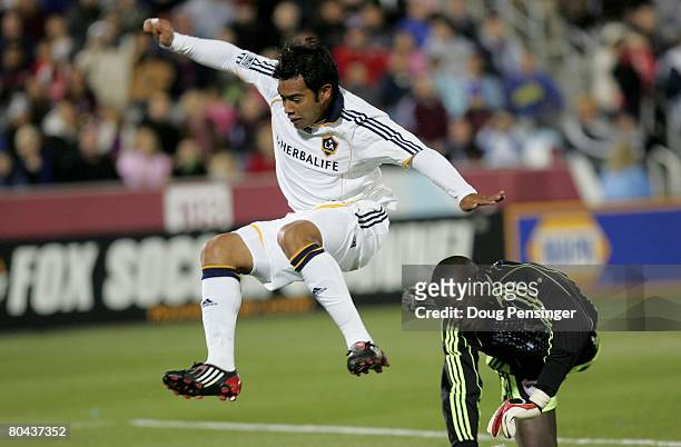 Goalkeeper Bouna Coundoul of the Colorado Rapids and Carlos Ruiz of the Los Angeles Galaxy collide as Ruiz pressures the goal at Dick's Sporting...