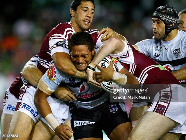 Manu Vatuvei of the Warriors is tackled during the round three NRL match between the Manly Warringah Sea Eagles and the Warriors at Brookvale Oval on...