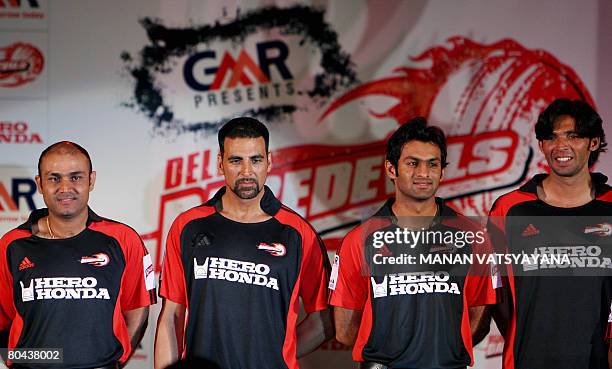 Indian cricketer and captain of IPL's Delhi Daredevils team Virender Sehwag poses with Bollywood Actor Akshay Kumar ,teammates and Pakistani...