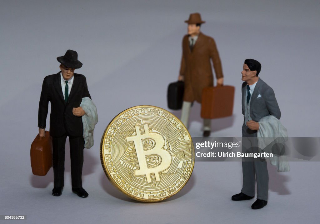 Bitcoin physically (gold) and manager miniature figures.