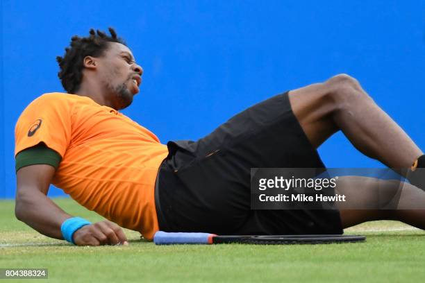 Gael Monfils of France falls against Richard Gasquet of France during Day 6 of the Aegon International Eastbourne tournament at Devonshire Park on...